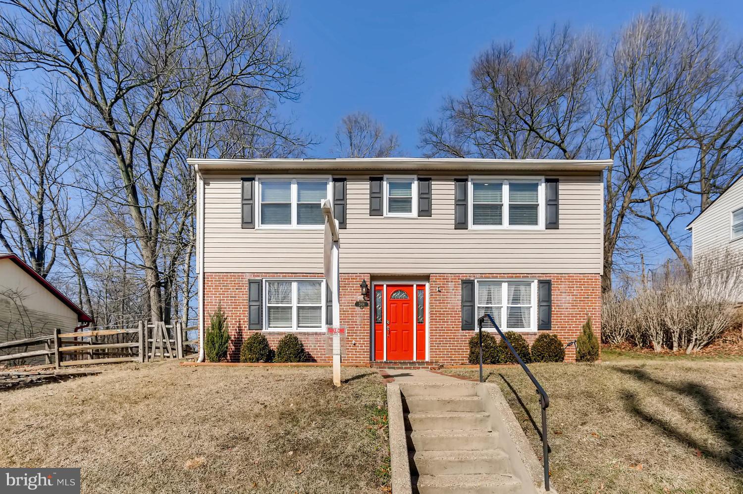 2406 Old Frederick Road Baltimore, MD 21228 - Photo 1 of 25 a front view of a house with a yard covered in snow
