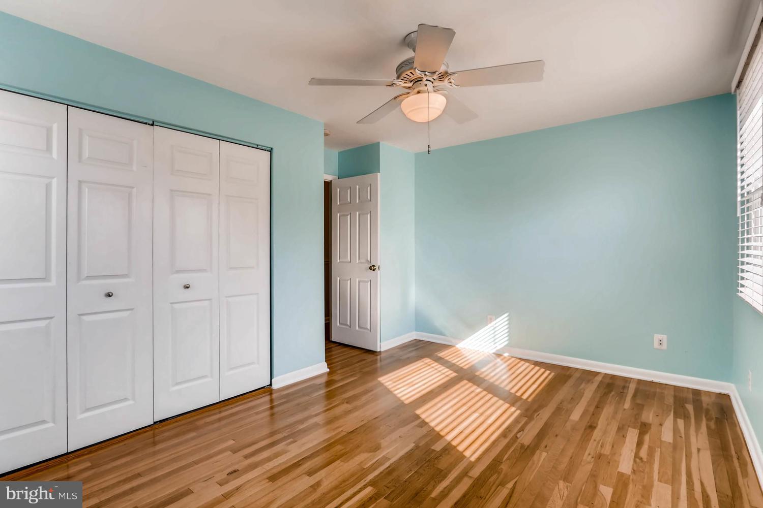 2406 Old Frederick Road Baltimore, MD 21228 - Photo 11 of 25 a view of a room with wooden floor and white walls