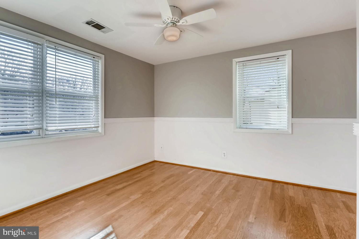 2406 Old Frederick Road Baltimore, MD 21228 - Photo 13 of 25 a view of empty room with wooden floor and fan