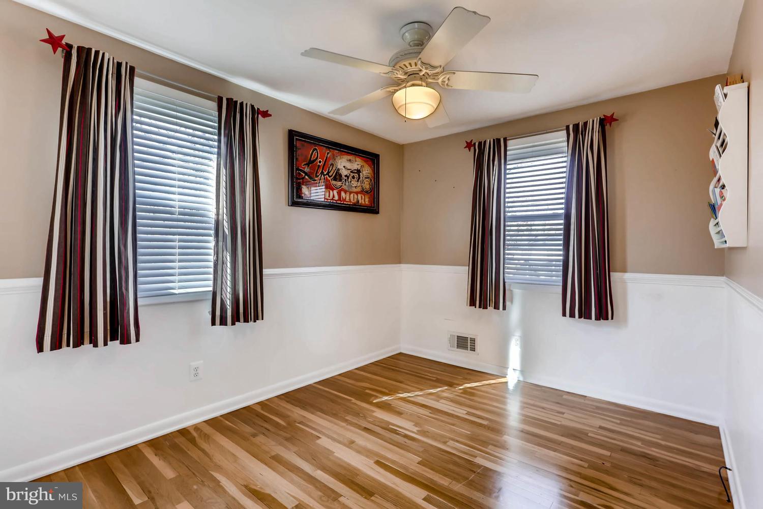 2406 Old Frederick Road Baltimore, MD 21228 - Photo 14 of 25 a view of a livingroom with wooden floor and workspace