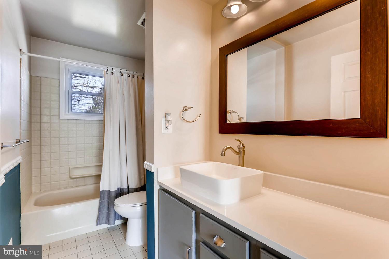 2406 Old Frederick Road Baltimore, MD 21228 - Photo 15 of 25 a bathroom with a sink a toilet and a bathtub