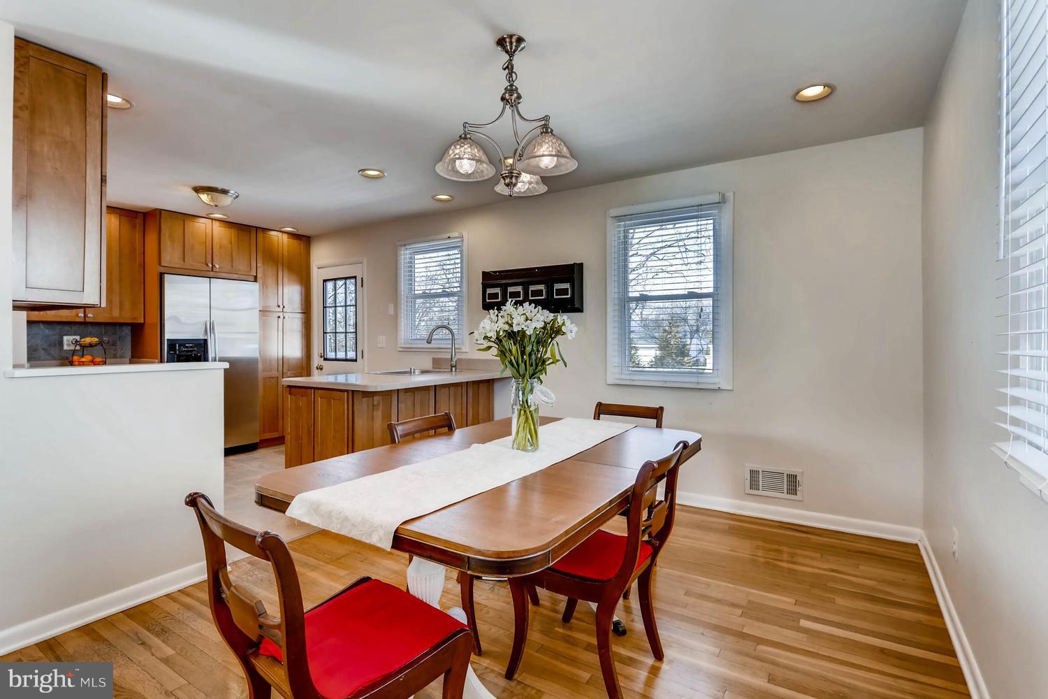 2406 Old Frederick Road Baltimore, MD 21228 - Photo 5 of 25 a view of a dining room with furniture window and wooden floor