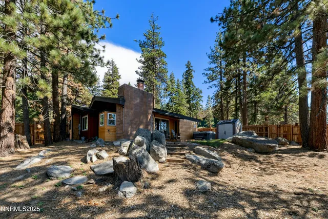 a backyard of a house with barbeque oven and outdoor seating