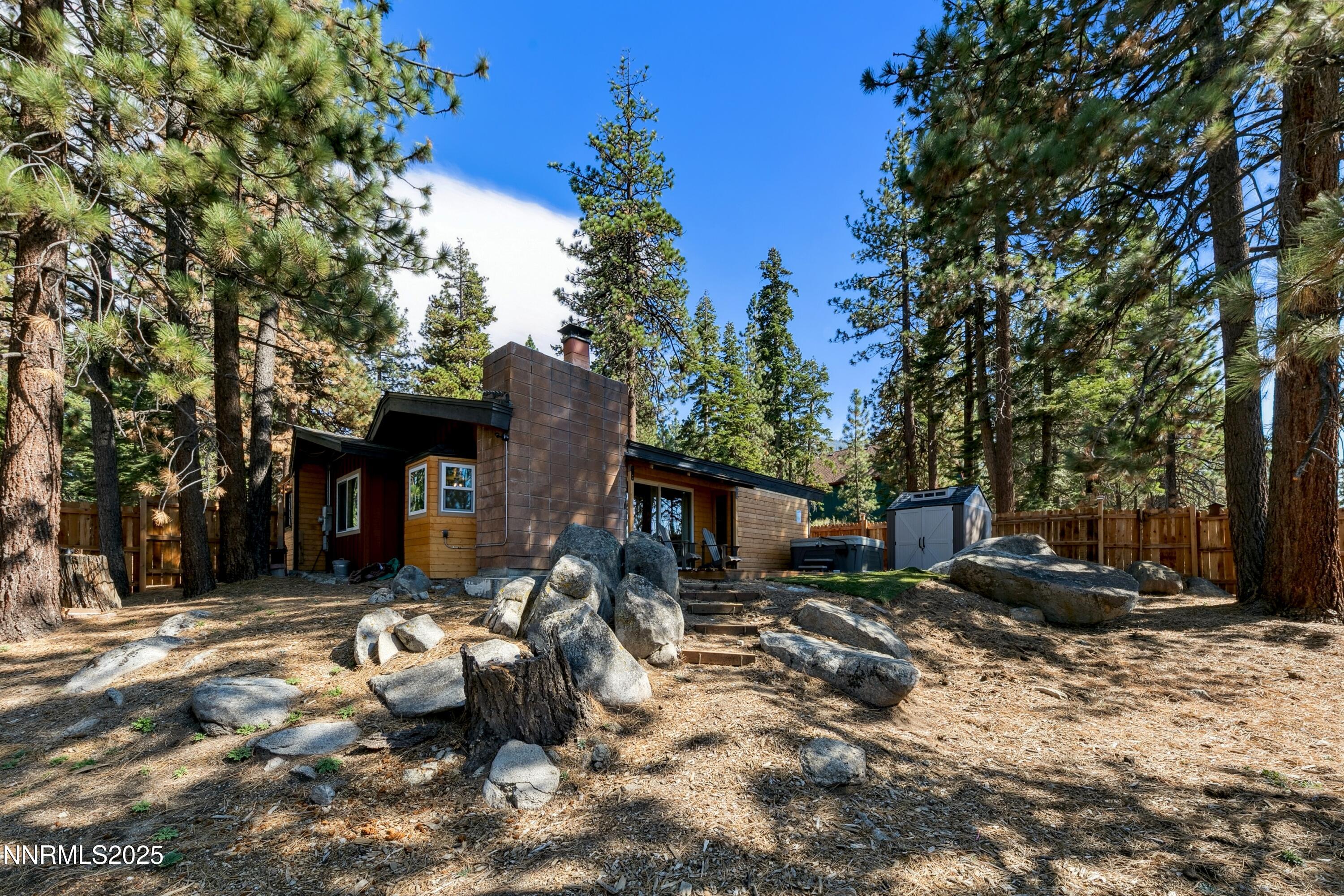 150 Woodland Way Stateline, NV 89449 - Photo 20 of 22 a backyard of a house with barbeque oven and outdoor seating