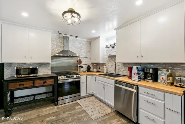 a kitchen with stainless steel appliances granite countertop a stove and cabinets