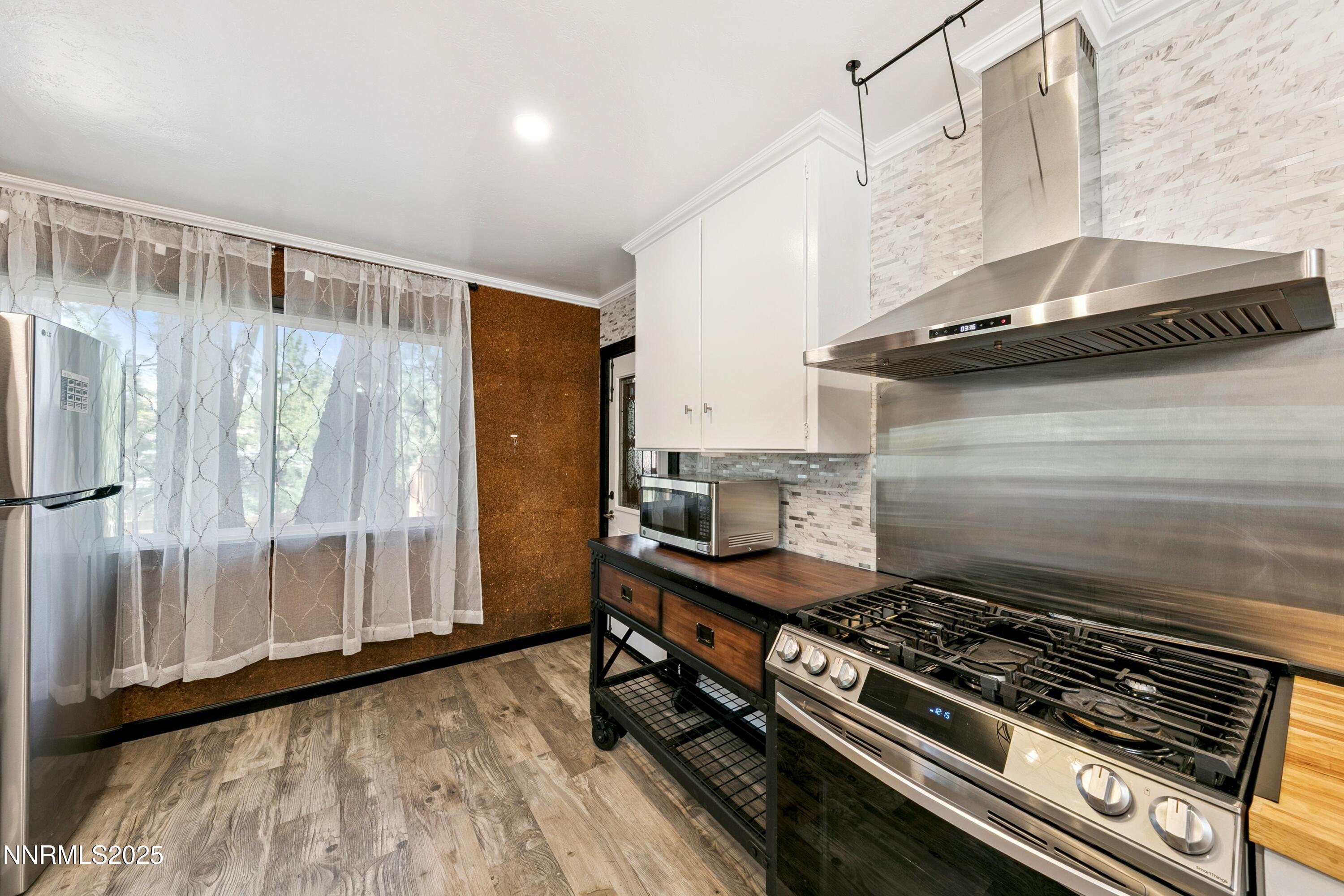 150 Woodland Way Stateline, NV 89449 - Photo 9 of 22 a kitchen with a stove and a wooden floor