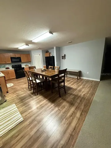 a dining room with furniture and wooden floor