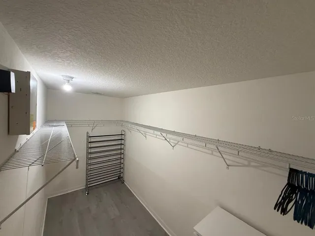 a bedroom with a bed next to a window