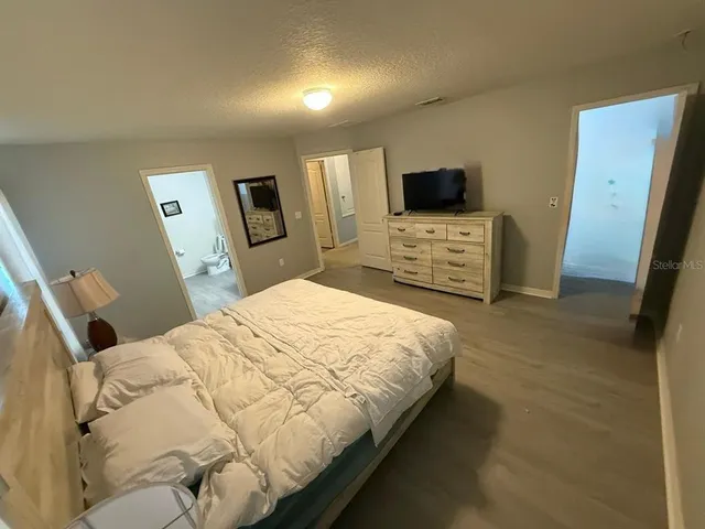 a bedroom with a bed and a mirror