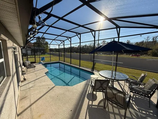 a view of a swimming pool with a patio