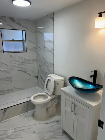 a bathroom with a toilet and a sink