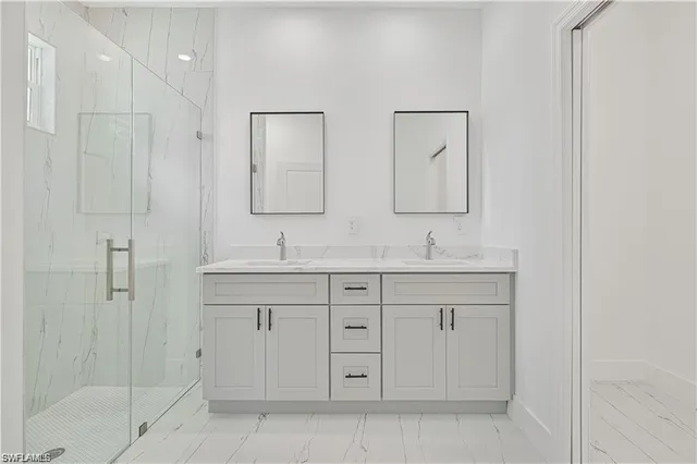 a bathroom with double sink and a mirror