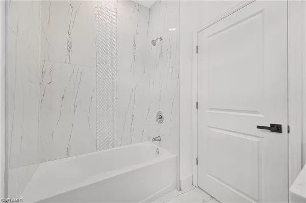 a bathroom with a shower and a sink