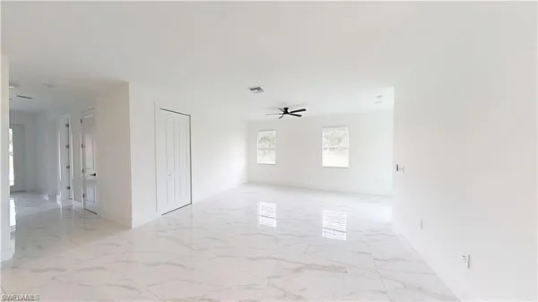 a view of a big room with closet and windows