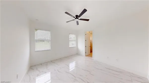 a view of a livingroom with a ceiling fan and window