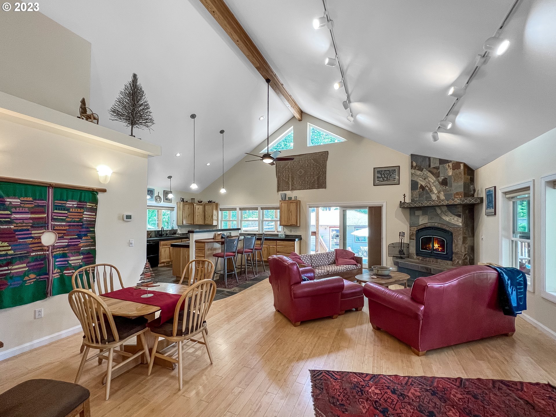 97313 Stagecoach Road Brookings, OR 97415 - Photo 16 of 44 a living room with furniture a fireplace and a ceiling fan