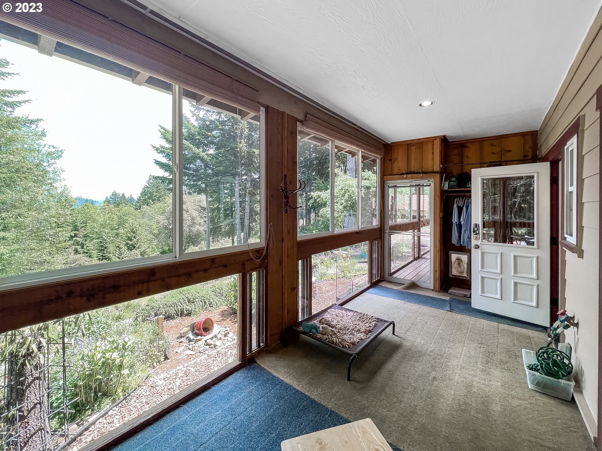 97313 Stagecoach Road Brookings, OR 97415 - Photo 19 of 44 a living room with furniture and a floor to ceiling window