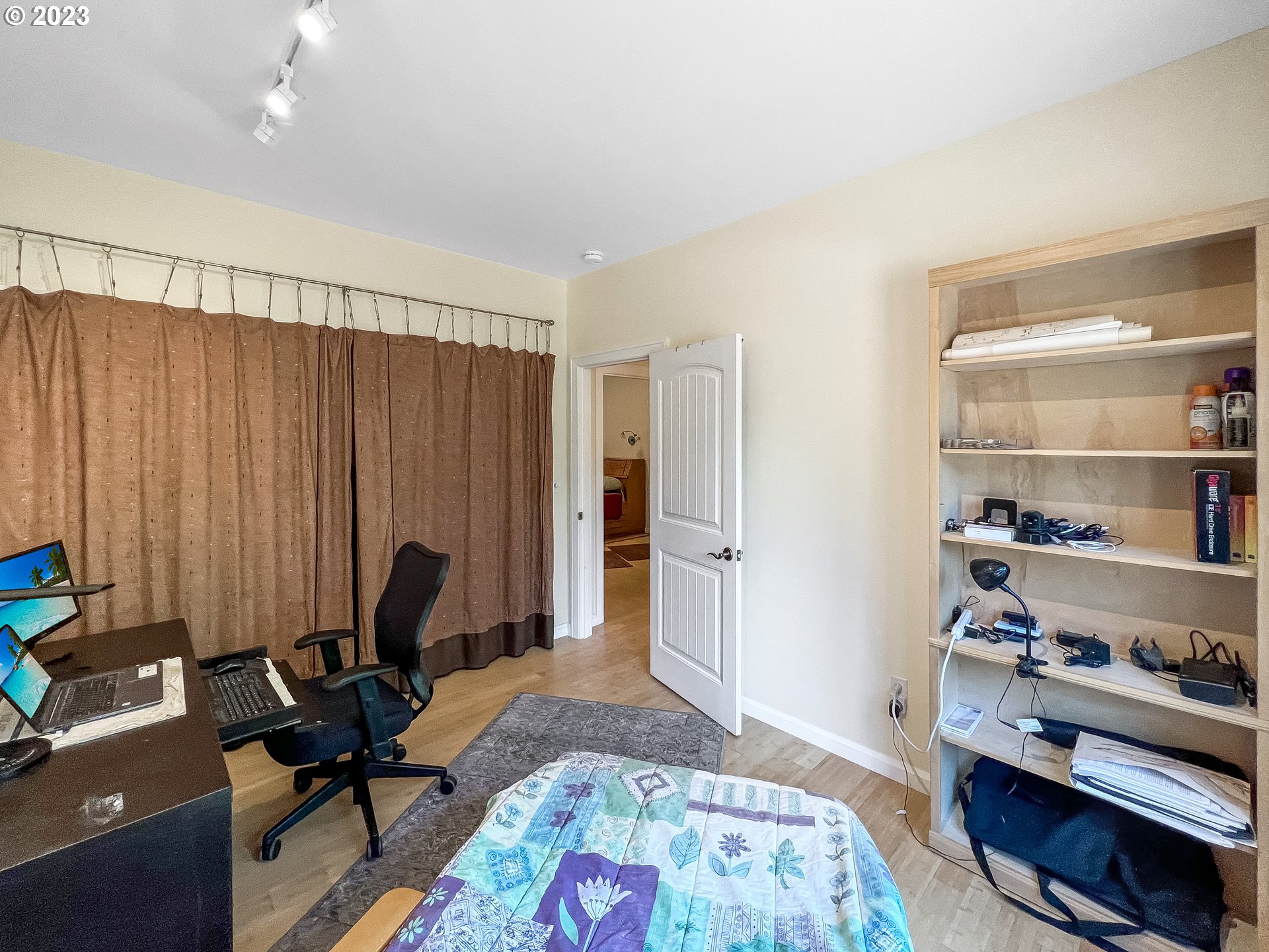 97313 Stagecoach Road Brookings, OR 97415 - Photo 21 of 44 a bed room with a bed and a book shelf