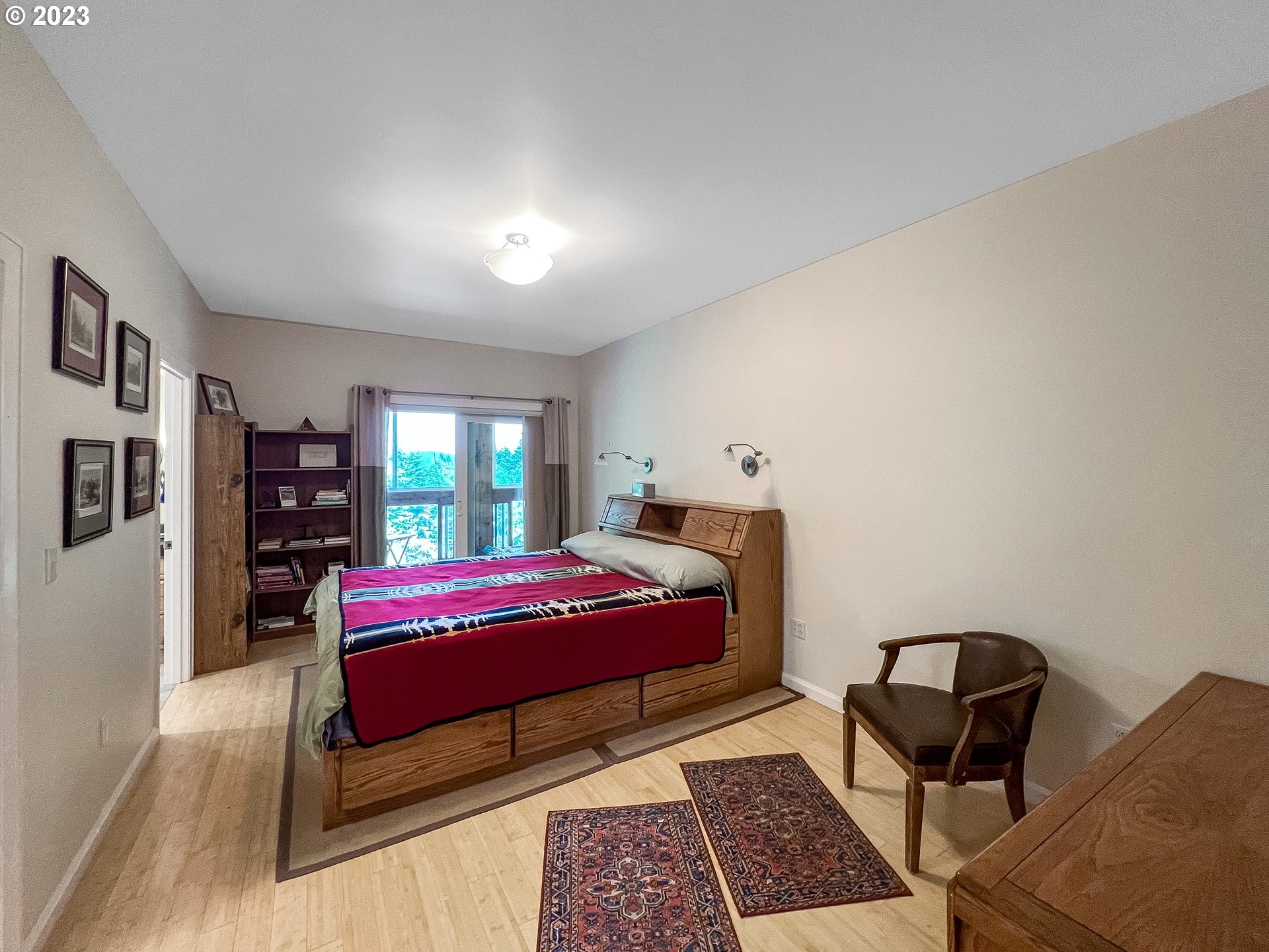 97313 Stagecoach Road Brookings, OR 97415 - Photo 22 of 44 a bedroom with a bed and wooden floor