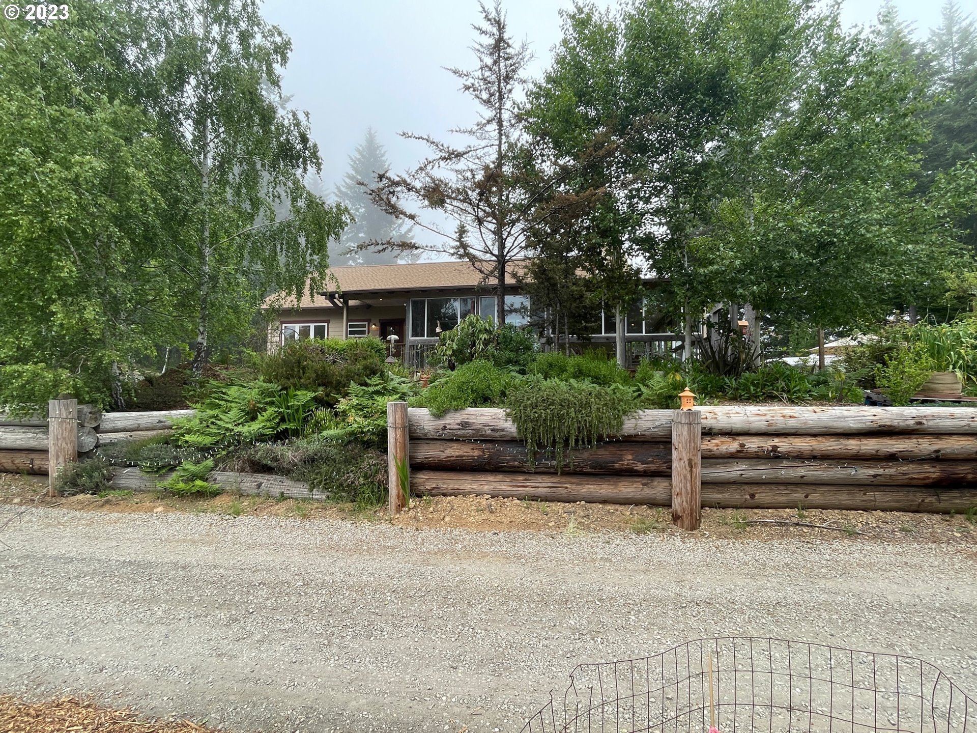 97313 Stagecoach Road Brookings, OR 97415 - Photo 3 of 44 a view of a terrace with a bench