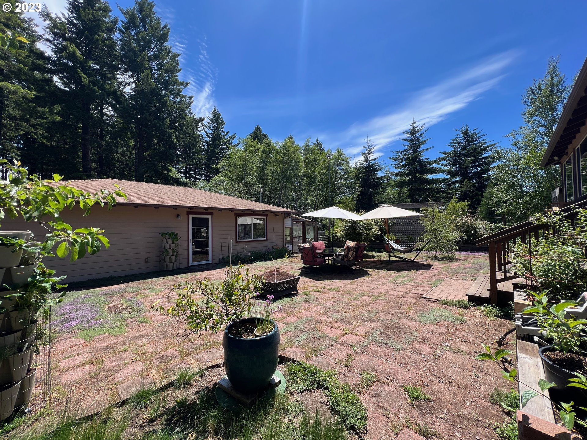 97313 Stagecoach Road Brookings, OR 97415 - Photo 35 of 44 a view of a patio with table and chairs and potted plants