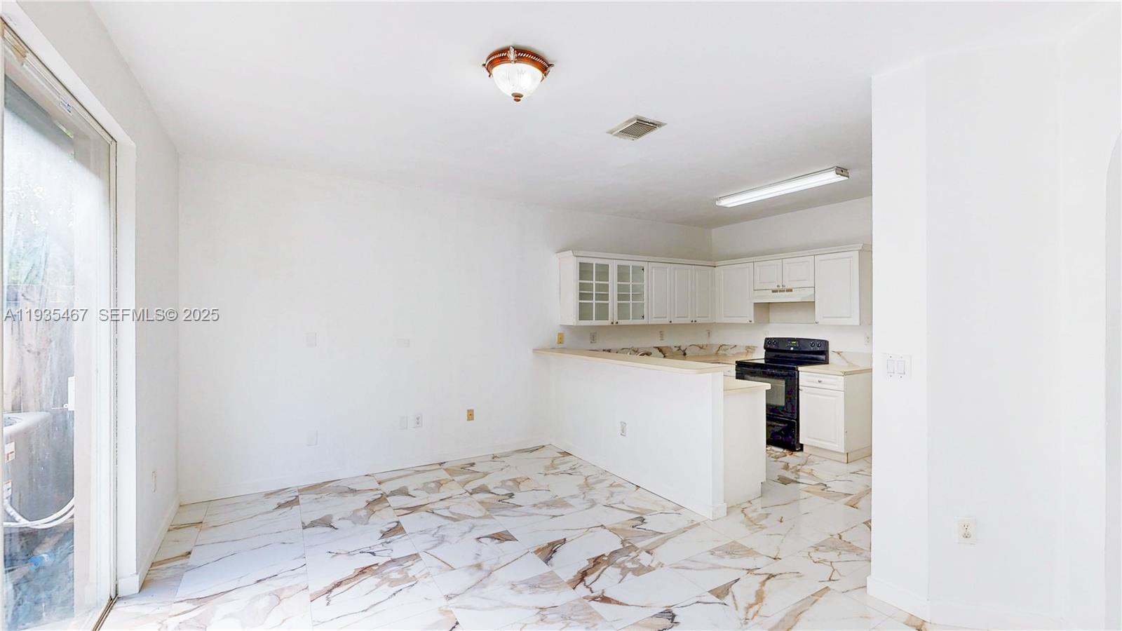 27345 Southwest 138th Court Homestead, FL 33032 - Photo 13 of 75 a room with a white bed and cabinets