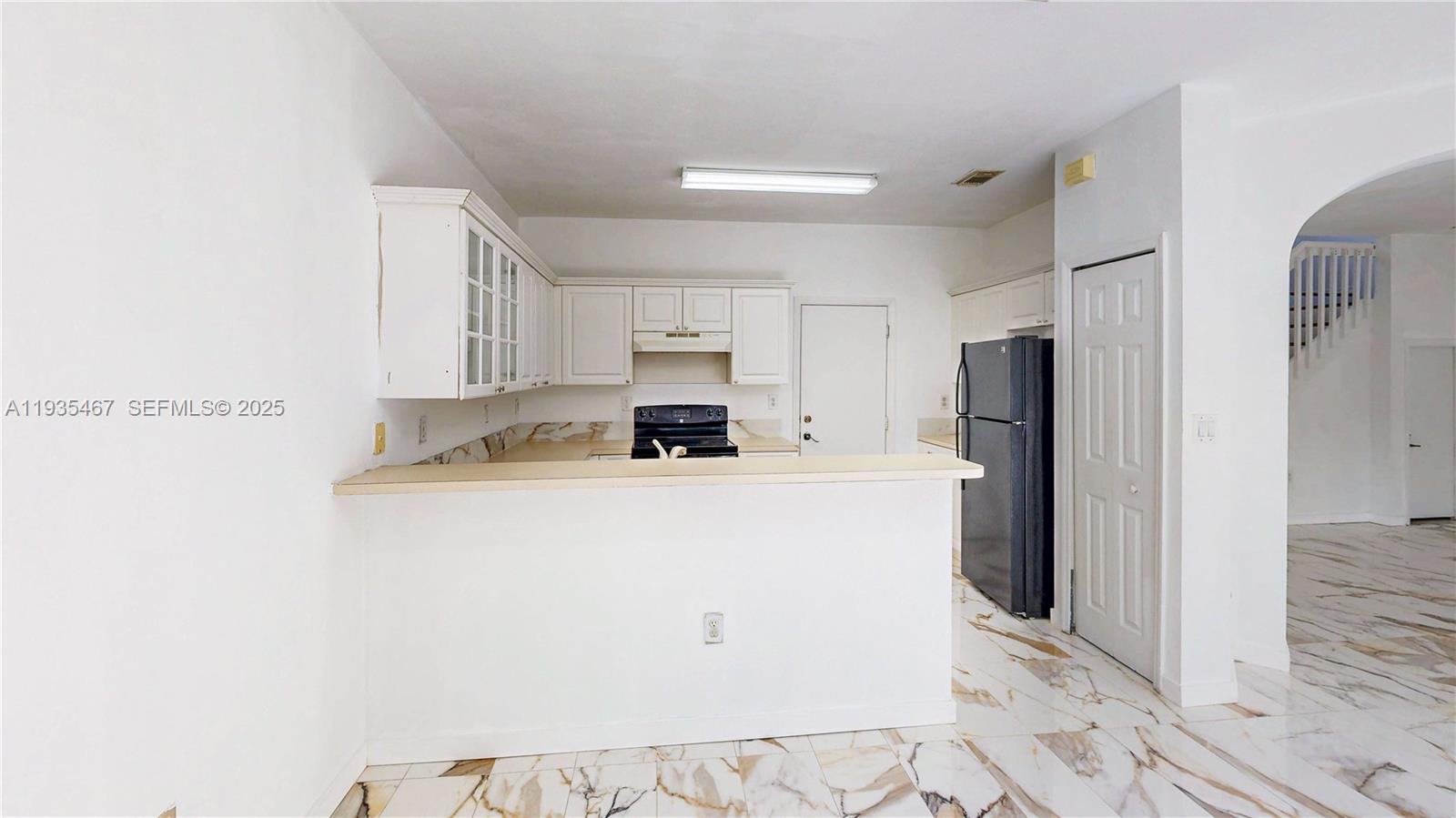 27345 Southwest 138th Court Homestead, FL 33032 - Photo 16 of 75 a kitchen with stainless steel appliances a refrigerator sink and white cabinets