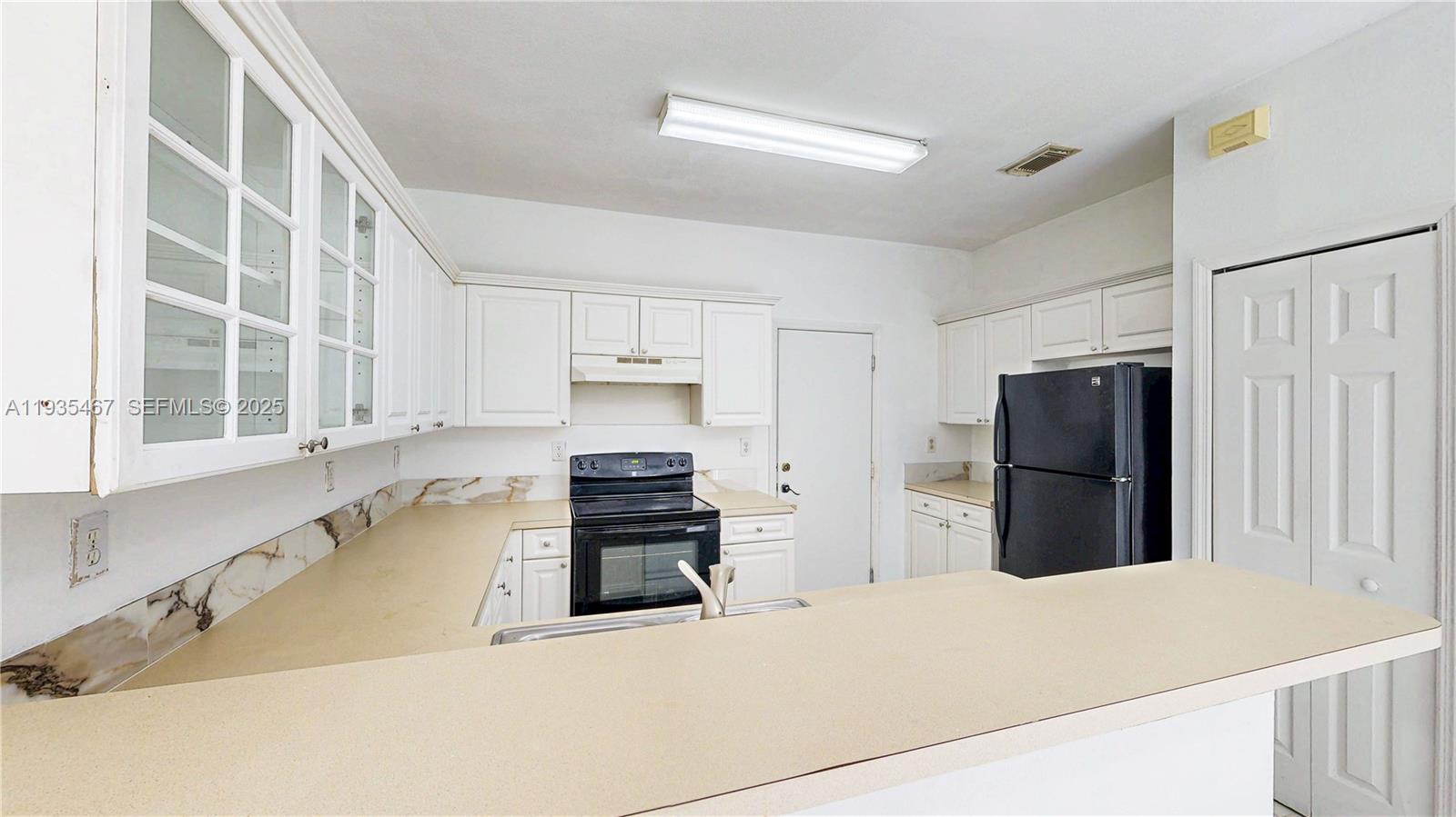 27345 Southwest 138th Court Homestead, FL 33032 - Photo 17 of 75 a kitchen with stainless steel appliances a refrigerator and a stove top oven