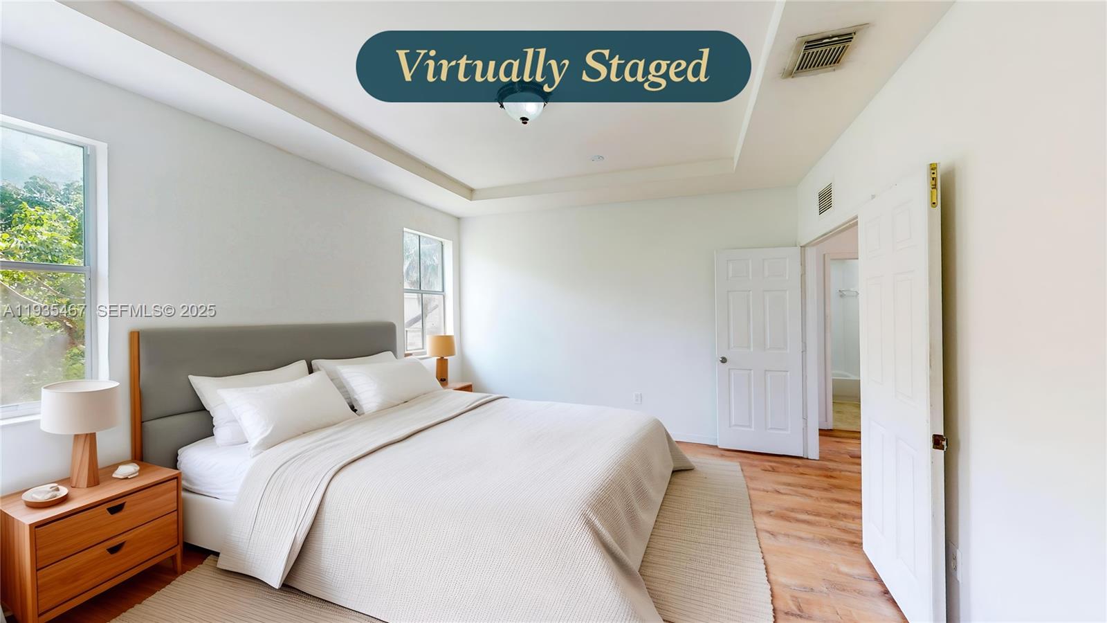 27345 Southwest 138th Court Homestead, FL 33032 - Photo 30 of 75 a bedroom with a bed and a night stand