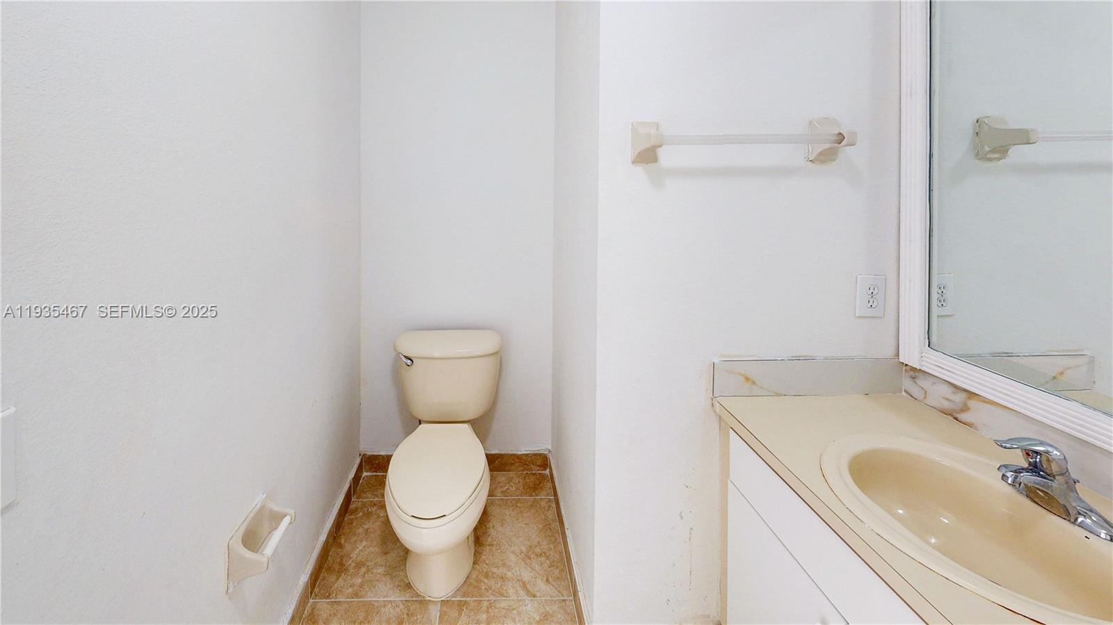 27345 Southwest 138th Court Homestead, FL 33032 - Photo 34 of 75 a bathroom with a sink a toilet and a mirror