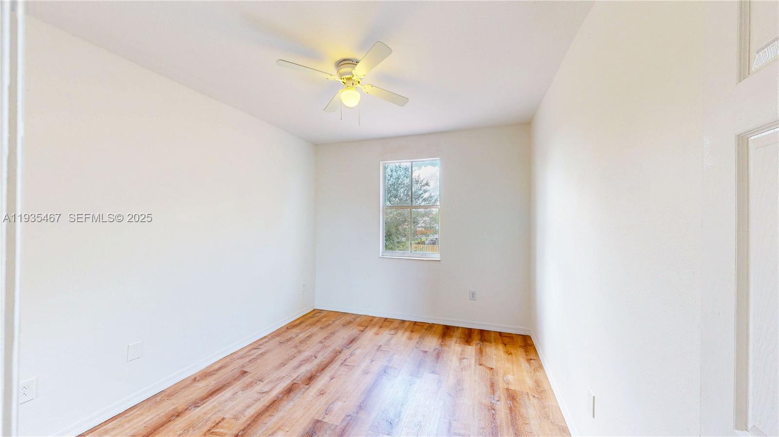 27345 Southwest 138th Court Homestead, FL 33032 - Photo 39 of 75 an empty room with wooden floor and natural light