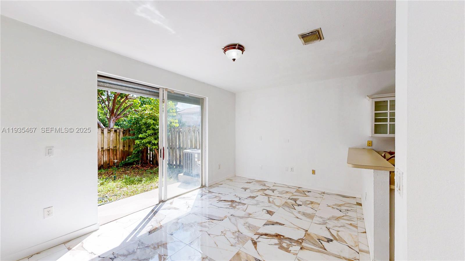 27345 Southwest 138th Court Homestead, FL 33032 - Photo 10 of 75 a view of a bedroom with wooden floor and a window