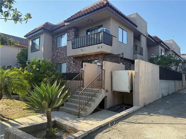 a view of a house with wooden fence