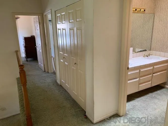 43982 Highlander Drive Temecula, CA 92592 - Photo 13 of 14 a bathroom with a double vanity sink and mirror