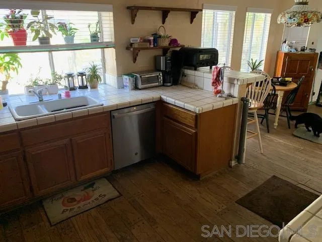 43982 Highlander Drive Temecula, CA 92592 - Photo 7 of 14 a kitchen with a sink cabinets and wooden floor