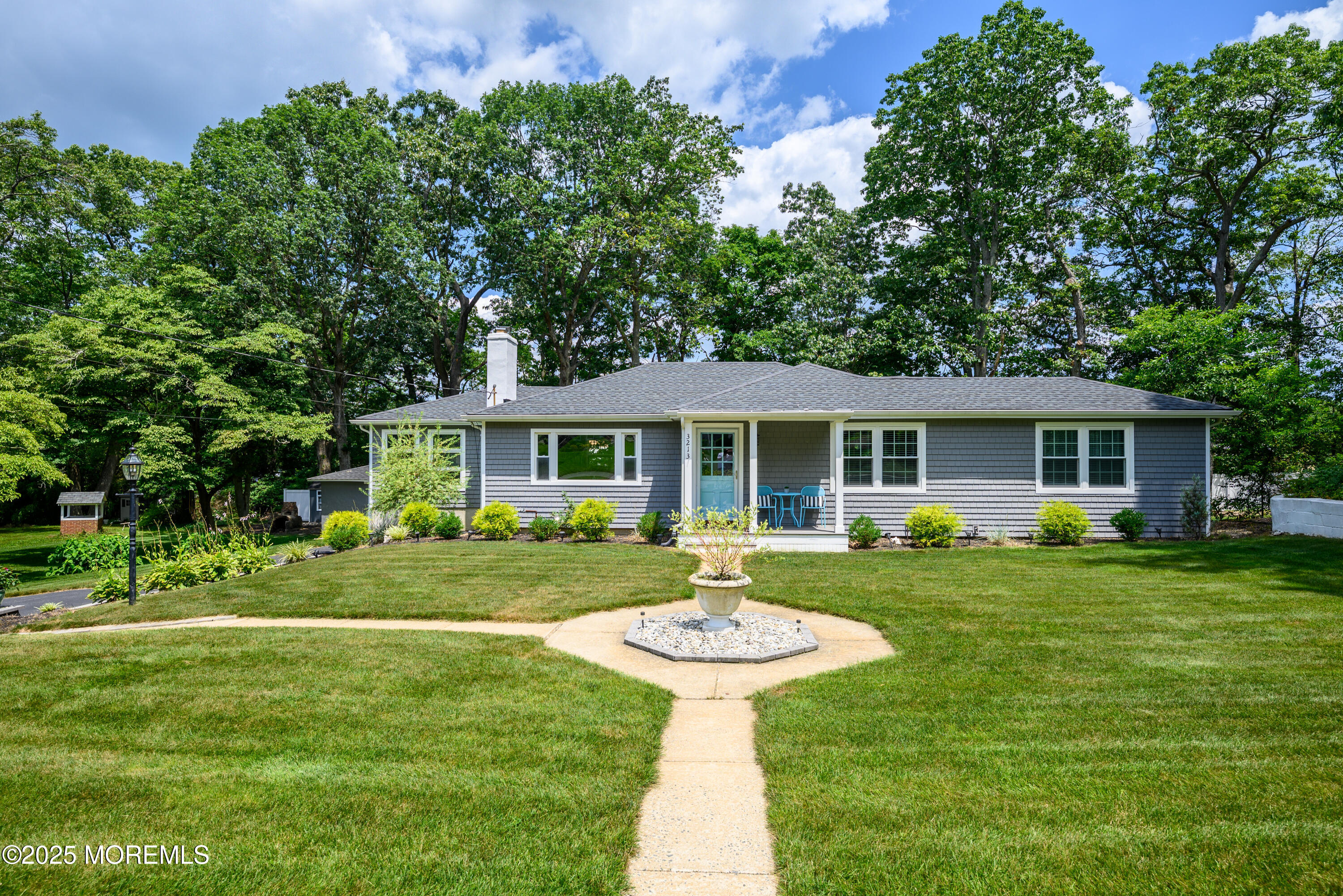 3213 Ridgewood Road Allenwood, NJ 08720 - Photo 1 of 42 a front view of a house with a garden and porch