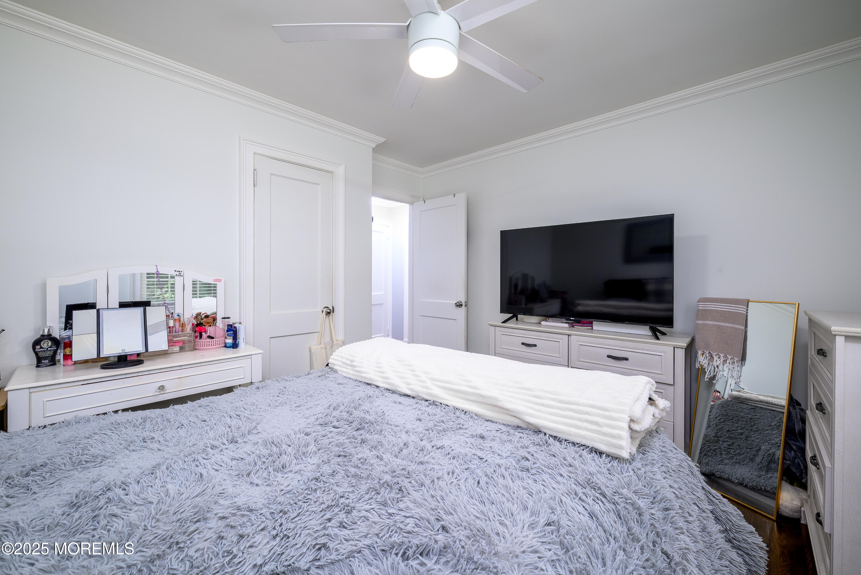 3213 Ridgewood Road Allenwood, NJ 08720 - Photo 24 of 42 a bedroom with a bed and a flat screen tv