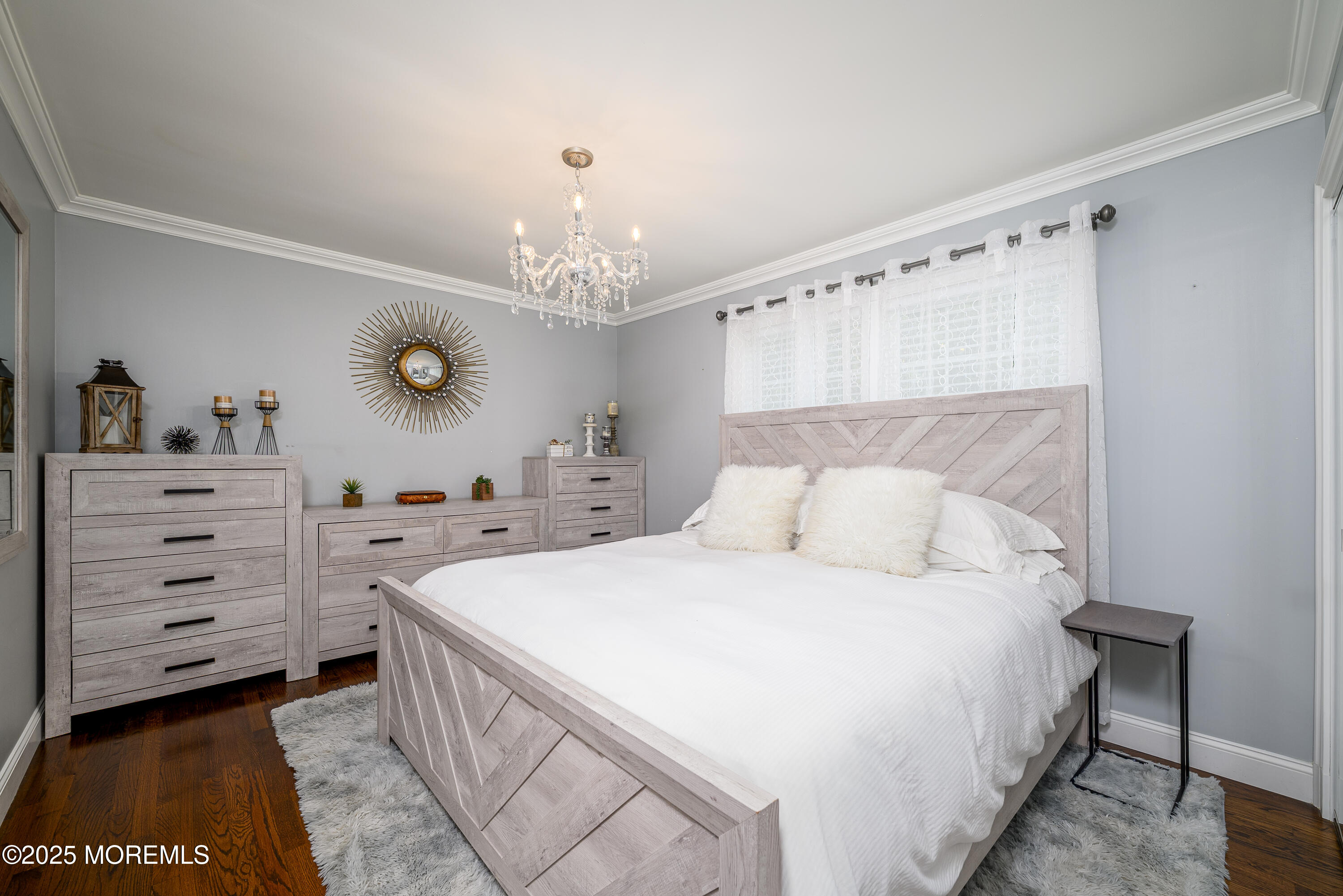 3213 Ridgewood Road Allenwood, NJ 08720 - Photo 26 of 42 a bedroom with a bed and a chandelier