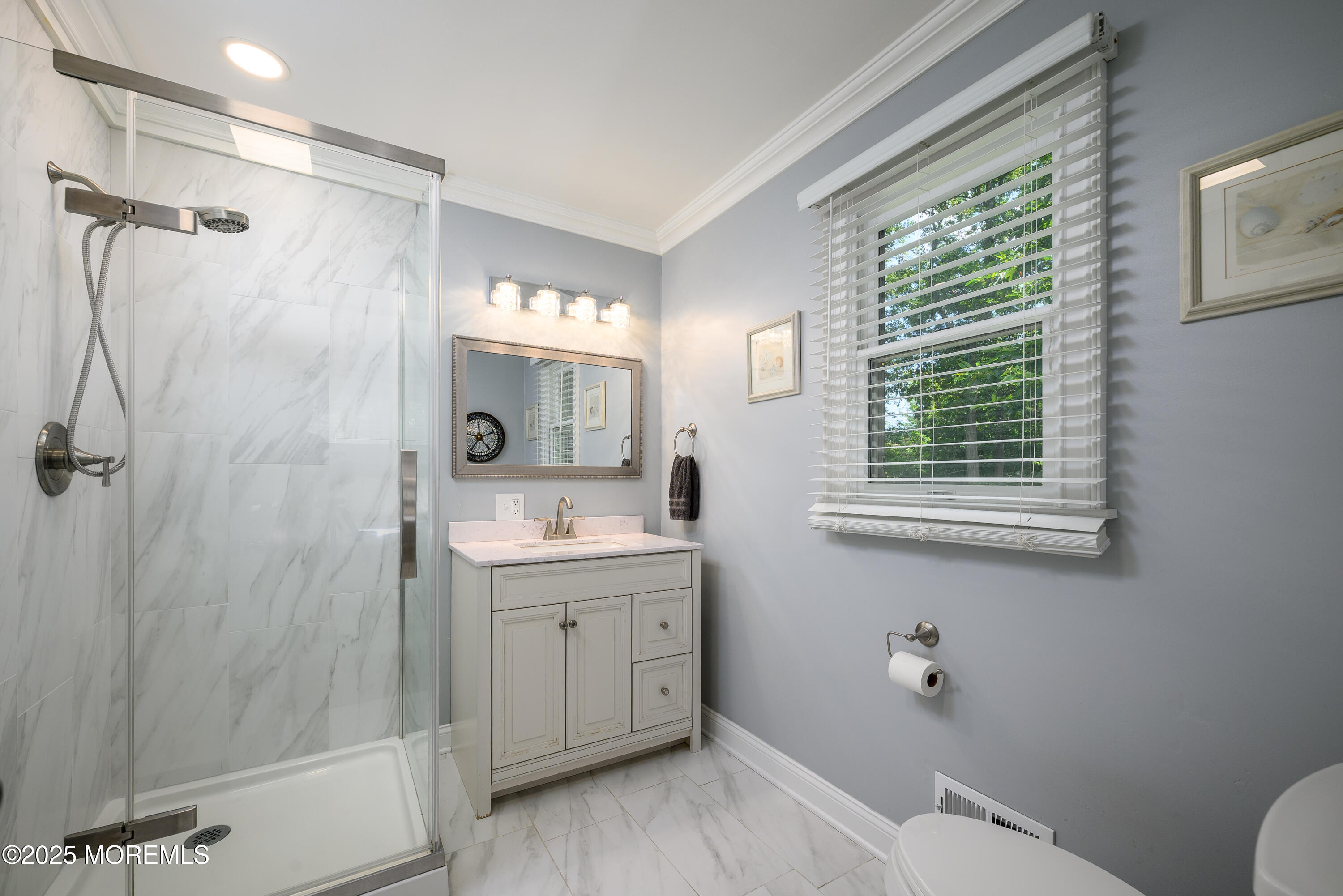 3213 Ridgewood Road Allenwood, NJ 08720 - Photo 28 of 42 a bathroom with a granite countertop sink toilet a large mirror a shower and a window