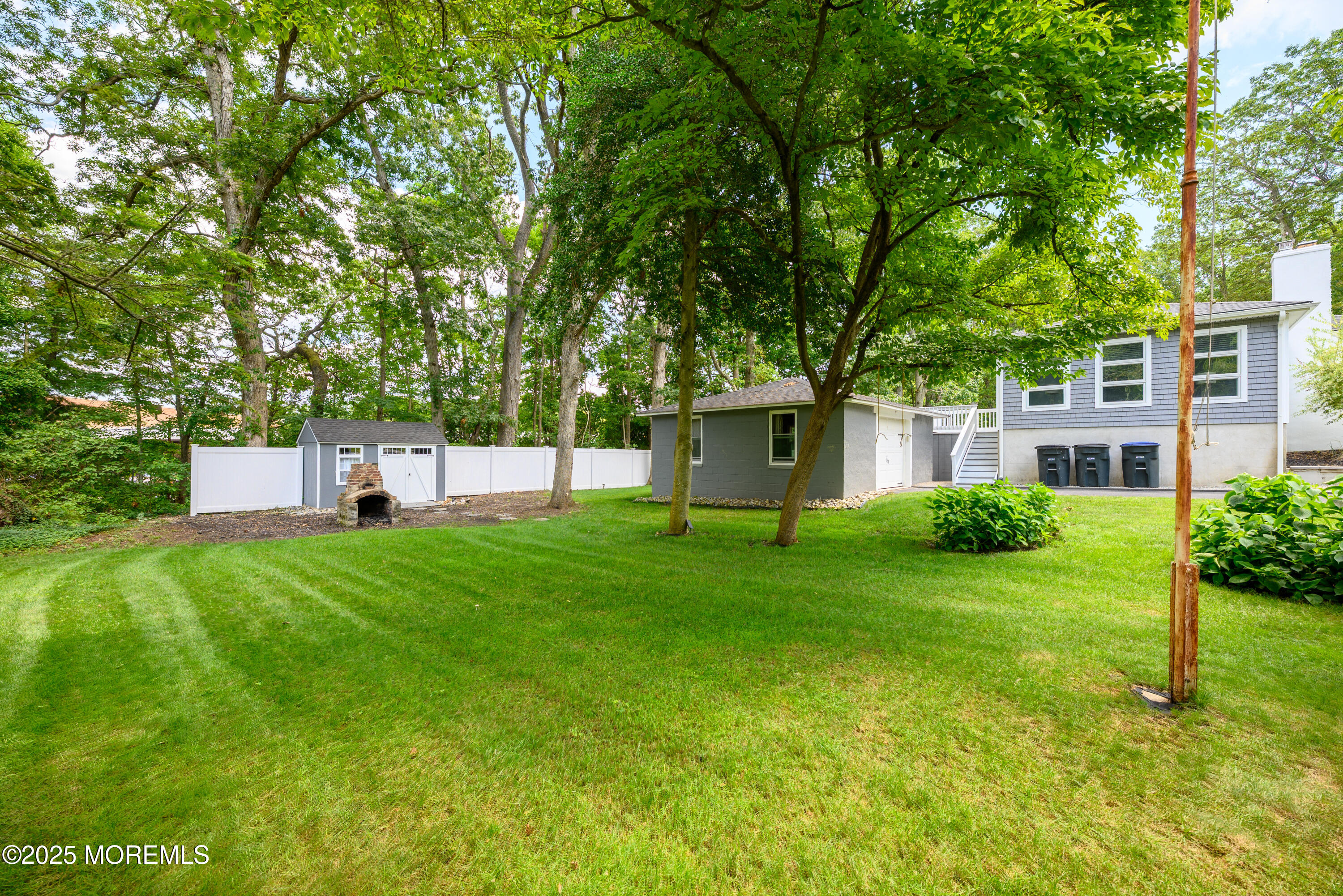 3213 Ridgewood Road Allenwood, NJ 08720 - Photo 6 of 42 a front view of a house with a yard and trees
