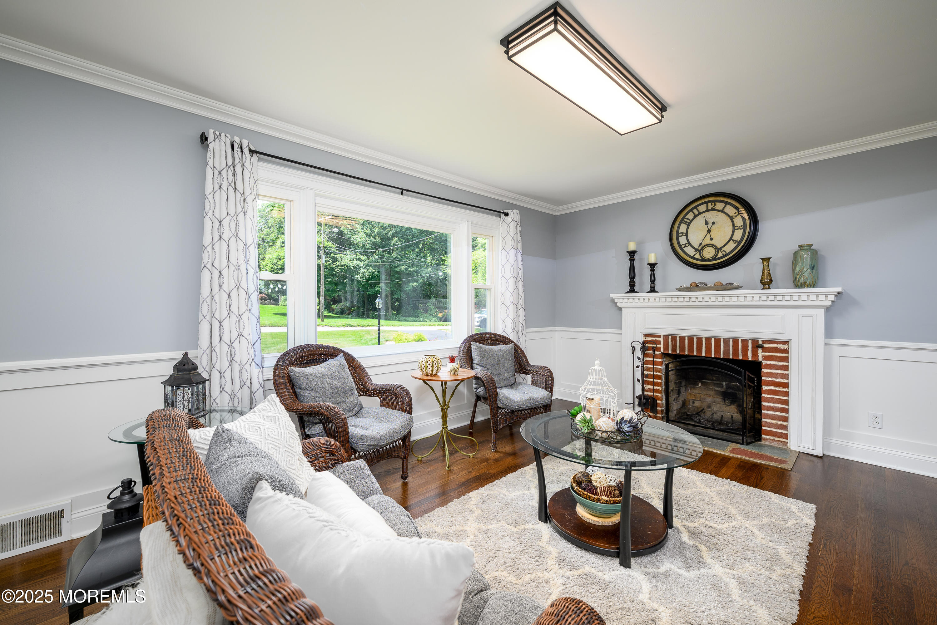 3213 Ridgewood Road Allenwood, NJ 08720 - Photo 9 of 42 a living room with furniture a fireplace and a large window