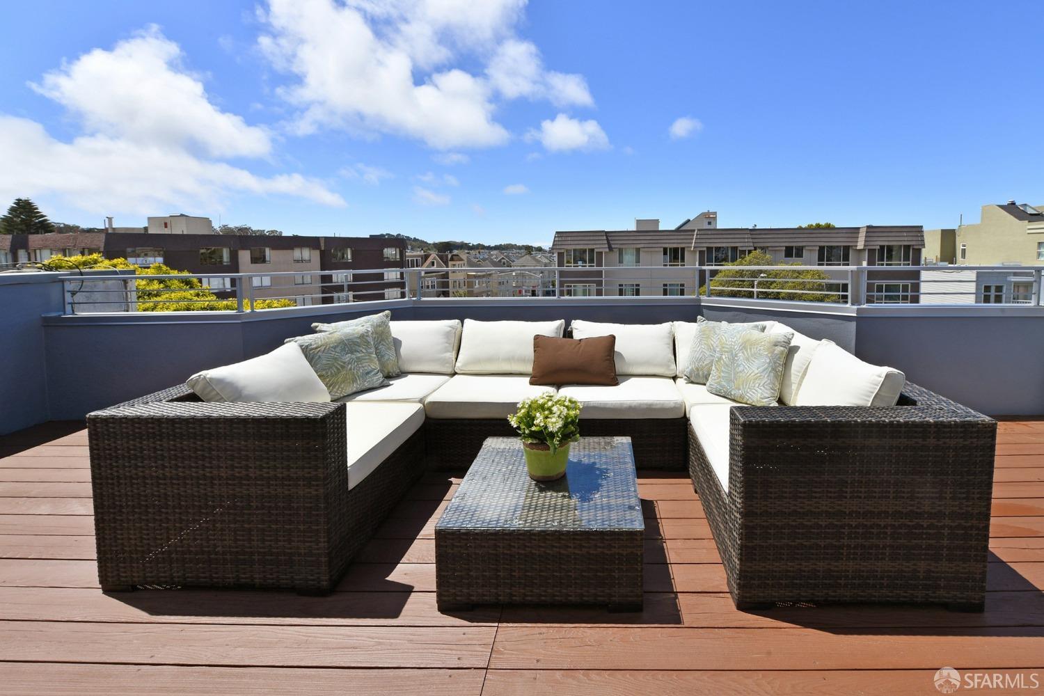 a view of roof deck with furniture