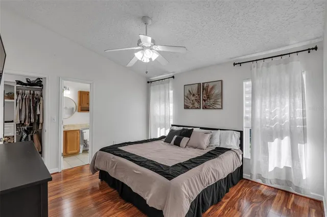a bedroom with a large bed and a chandelier