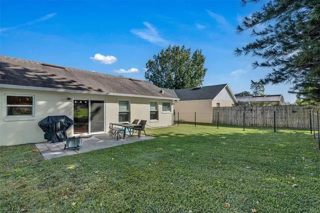 a view of a house with backyard porch and sitting area