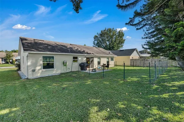 a view of a house with a backyard