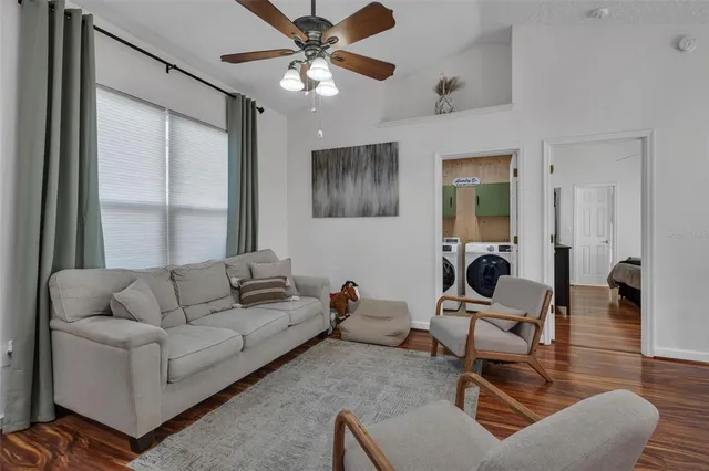 a living room with furniture and a chandelier