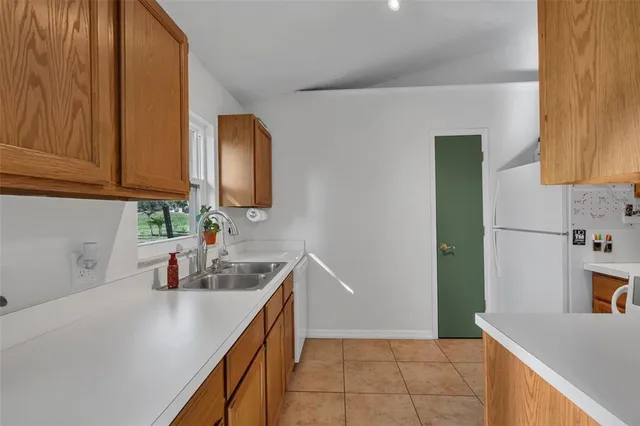 a kitchen with stainless steel appliances a sink dishwasher stove and cabinets