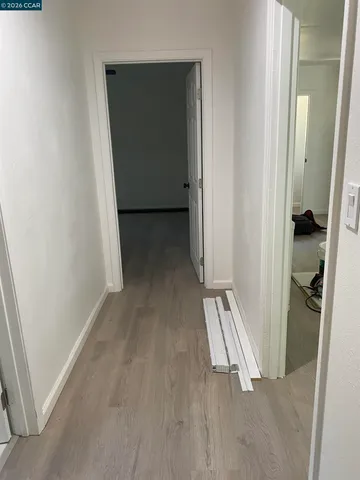 en empty room with windows and ceiling fan