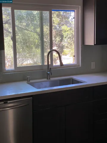 a kitchen with a sink and cabinets