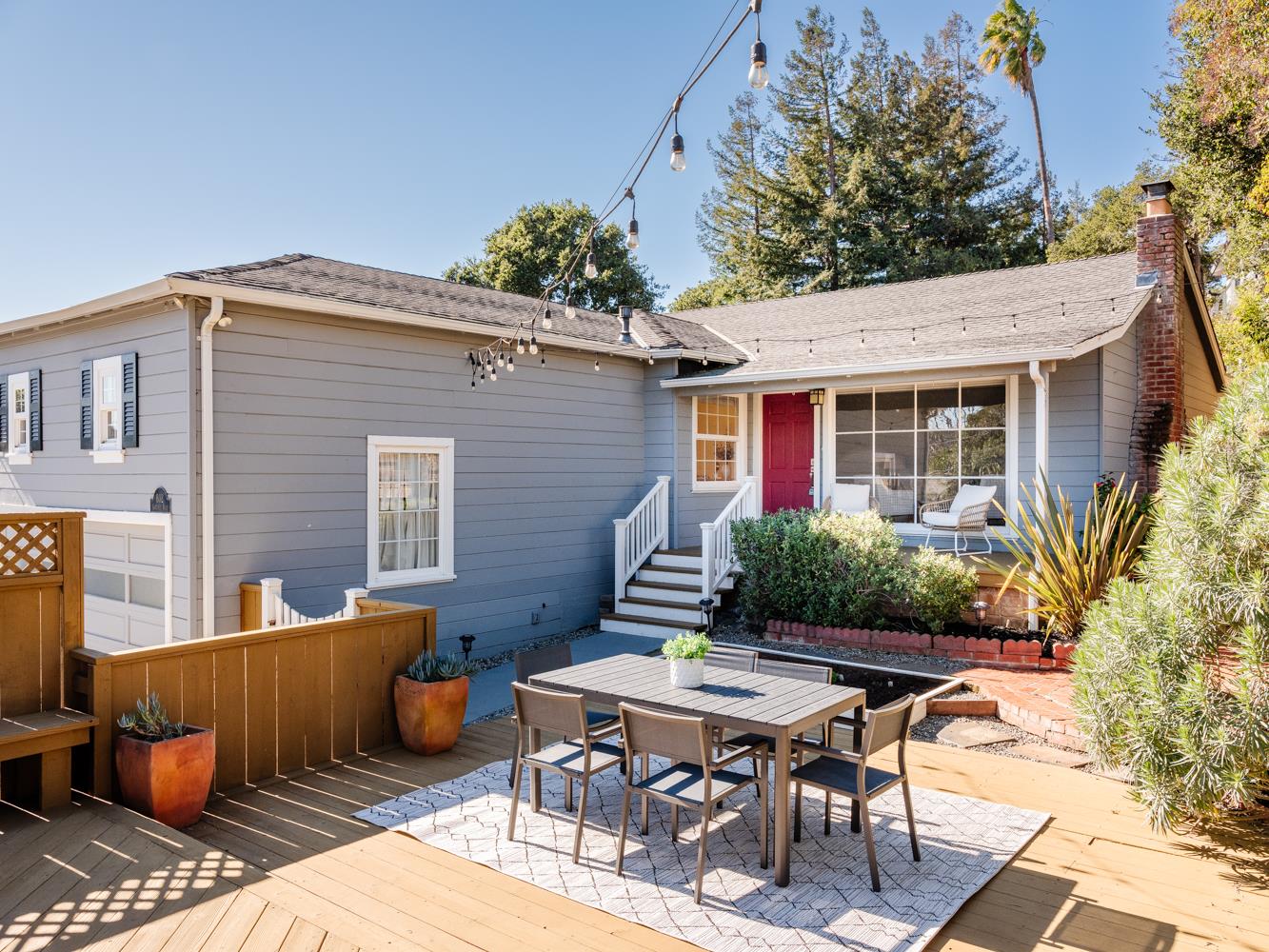a backyard of a house with table and chairs